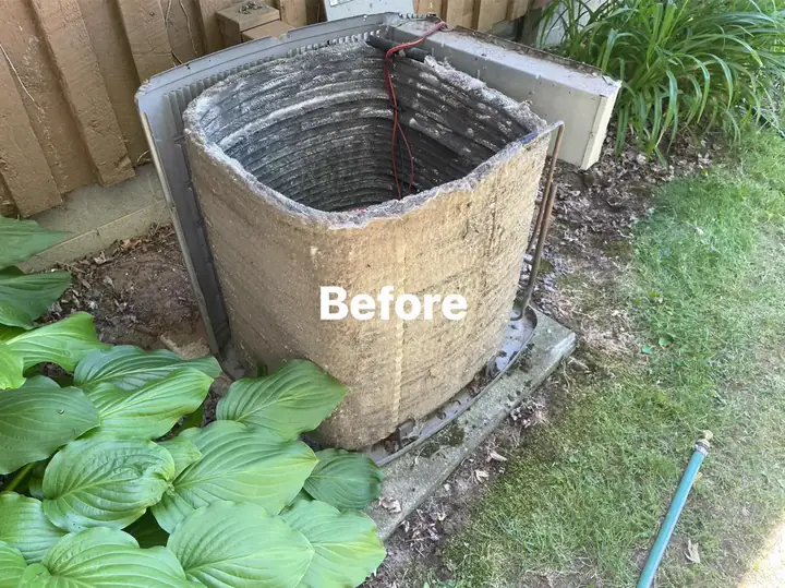 Air conditioner coil before maintenance, covered with debris